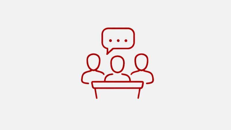 Icon of three people sitting with a speech bubble above