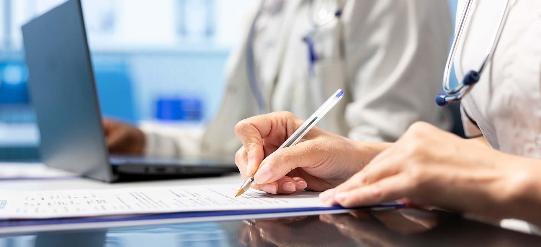Physician writing a prescription treatment