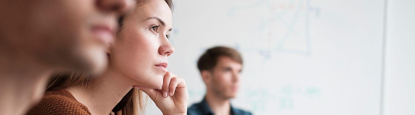 Professionals attentively listening during a business meeting.